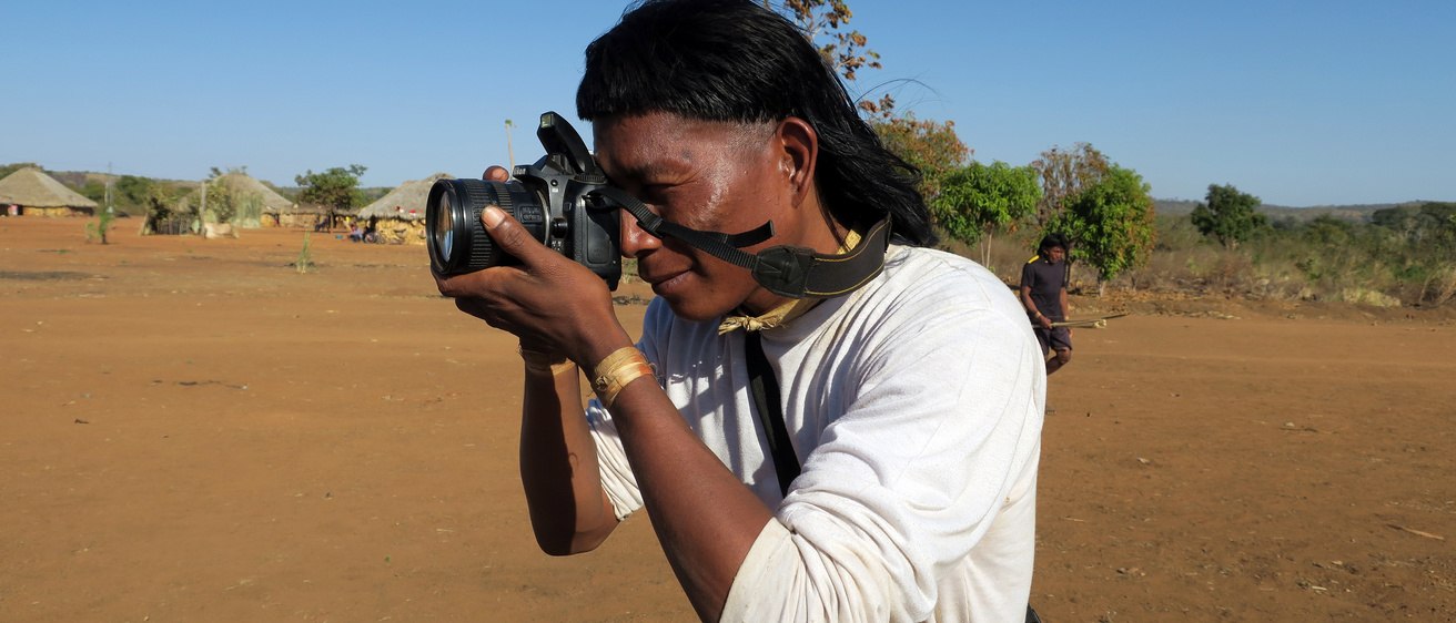 A photographer in the field with a camera.