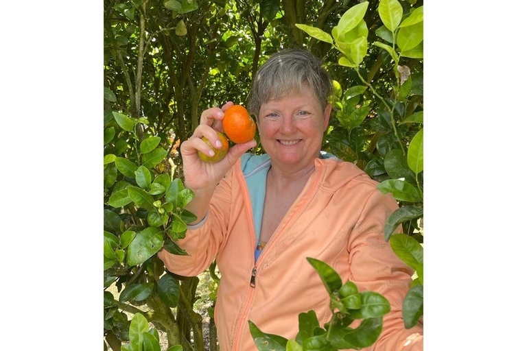 Photo of Kristine Muñoz holding an orange