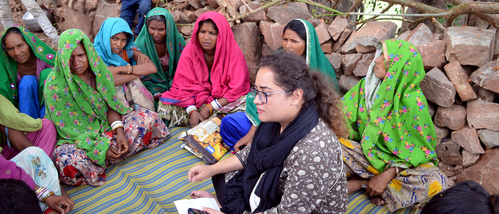 A student intern discussing local concerns with villagers.